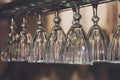 Glasses hanging on bar rack close up Royalty Free Stock Photo