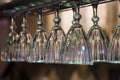 Glasses hanging on bar rack close up
