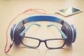 Glasses headphone and smartphone on wood floor Royalty Free Stock Photo