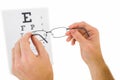 Glasses held up to read eye test Royalty Free Stock Photo