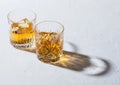 Glasses with ice cubes of single malt whiskey on white background Royalty Free Stock Photo