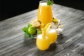 Glasses and jug with fresh lemon juice on wooden table Royalty Free Stock Photo