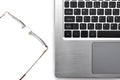 Glasses and laptop computer keyboard. Vision problems at work with computers. Royalty Free Stock Photo