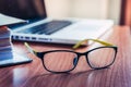 Glasses and laptop on the desk work place Royalty Free Stock Photo