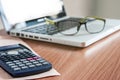 Glasses and laptop on the desk work place Royalty Free Stock Photo