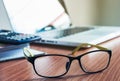 Glasses and laptop on the desk work place Royalty Free Stock Photo