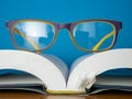 Glasses lay on top of opened book Royalty Free Stock Photo