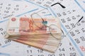 Glasses lie on a bundle of five-thousandth Russian banknotes, background from calendar sheets Royalty Free Stock Photo