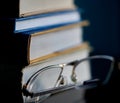 Glasses lie on a stack of books, science Royalty Free Stock Photo