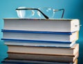 Glasses lie on a stack of books, science Royalty Free Stock Photo