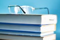Glasses lie on a stack of books, science Royalty Free Stock Photo