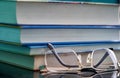 Glasses lie on a stack of books, science Royalty Free Stock Photo