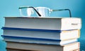 Glasses lie on a stack of books, science Royalty Free Stock Photo
