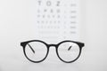 Glasses on light background, closeup. Ophthalmologist prescription