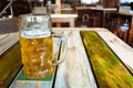 Glasses of light beer on pub background. Pint glass of golden beer with snacks Royalty Free Stock Photo