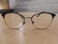 Glasses are on light brown table with black frame with white brick wllpaper background Royalty Free Stock Photo