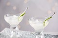 Glasses of martini with cucumber on tray against light background, closeup Royalty Free Stock Photo