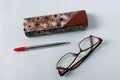Glasses next to the case and red handle Royalty Free Stock Photo