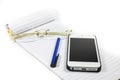 Glasses notebook pen telephone Royalty Free Stock Photo
