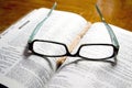 Glasses on Open Bible Royalty Free Stock Photo