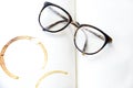Glasses on the open book, with coffee cup print Royalty Free Stock Photo