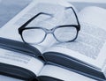 Glasses and open books on the table Royalty Free Stock Photo