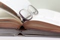 Glasses and open books on the table Royalty Free Stock Photo