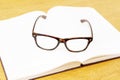 Glasses on open empty book Royalty Free Stock Photo