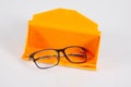 Glasses optical medical new in open orange case pyramid on a grey background table