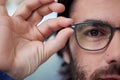 Glasses, optometry and eye of man fitting prescription eyewear, spectacles and holding specs. Half, face and portrait of Royalty Free Stock Photo