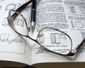 Glasses and pen on a book