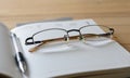 Glasses and pen on diary Royalty Free Stock Photo