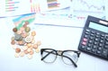 Close up a glasses,pencil, money, calculator and chart or graph on office desk table.Finance and business concept. Royalty Free Stock Photo