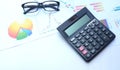 Close up a glasses,pencil, money, calculator and chart or graph on office desk table.Finance and business concept. Royalty Free Stock Photo