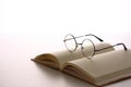 Glasses placed on books on the white table.