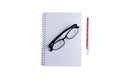 The glasses are placed on a notebook or book and a red pen is placed nearby.on isolated or white background Royalty Free Stock Photo