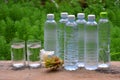 Glasses and plastic bottles of cool water Royalty Free Stock Photo