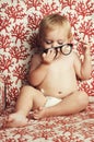 Glasses, playing and sweet baby in a studio with vision, health or eye care accessory for development. Cute, eyewear and Royalty Free Stock Photo