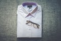 Glasses put on purple folded mens shirt