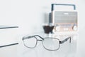 Glasses with radio, book and coffee