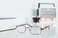 Glasses with radio, book and coffee