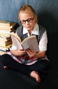 Glasses, reading and child student with a book in the classroom for education, learning or knowledge. Studying, nerd and Royalty Free Stock Photo