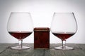 Glasses with red dry wine. Gift in a box. Stand on wooden boards. Shot in backlight Royalty Free Stock Photo