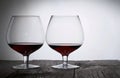 Glasses with red dry wine. Stand on wooden boards. Shot in backlight Royalty Free Stock Photo