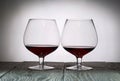 Glasses with red dry wine. Stand on wooden boards. Shot in backlight Royalty Free Stock Photo