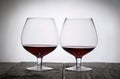 Glasses with red dry wine. Stand on wooden boards. Shot in backlight Royalty Free Stock Photo