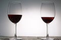 Glasses with red dry wine. Stand on wooden boards. Shot in backlight Royalty Free Stock Photo