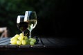 Glasses of red and white wine and grapes on a wooden table outdoor. Wine tasting concept. Copy space Royalty Free Stock Photo