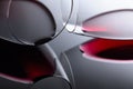 Glasses of red wine on a black reflective background Royalty Free Stock Photo