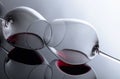 Glasses of red wine on a black reflective background Royalty Free Stock Photo